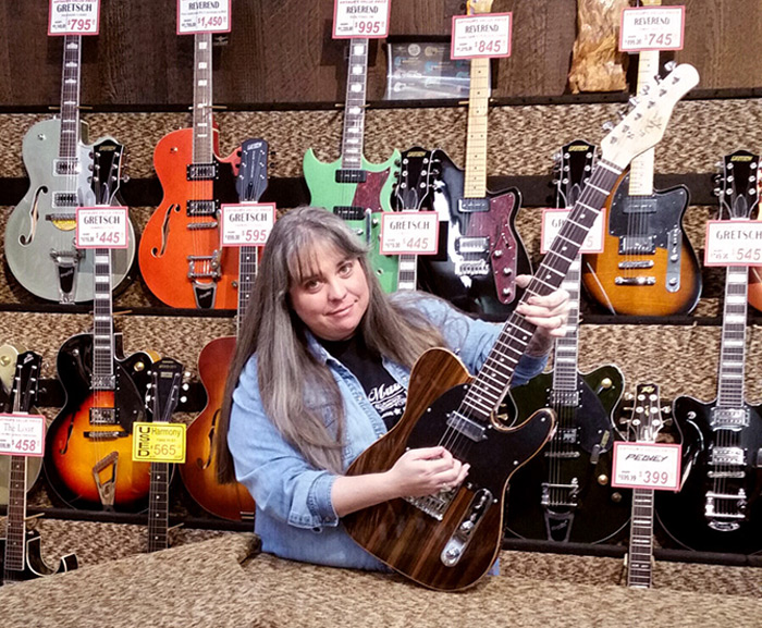 Amy at Arthur's Music Store with a Michael Kelly 1950s Ebony electric guitar Amy at Arthur's Music Store with a Michael Kelly 1950s Ebony electric guitar