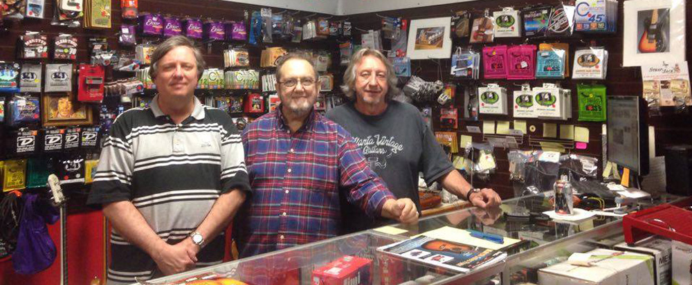 Atlanta Vintage Guitars staff manning the counter with guitar accessories and strings