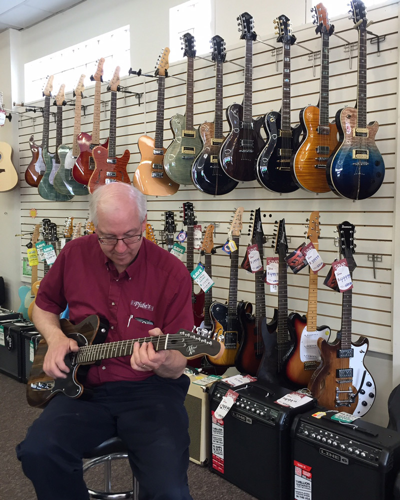 Pfabe's staff rocking a Michael Kelly 1950s Ebony electric guitar