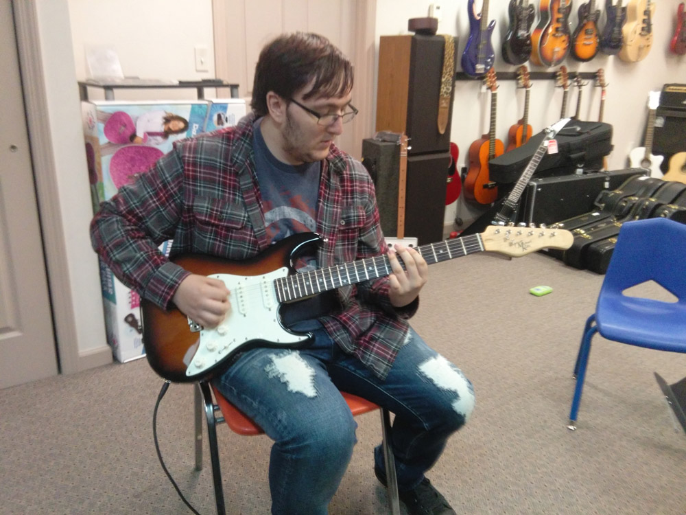 Student learning to play guitar at Robert Putt Studios on a Michael Kelly 1960s electric guitar. Student learning to play guitar at Robert Putt Studios on a Michael Kelly 1960s electric guitar.