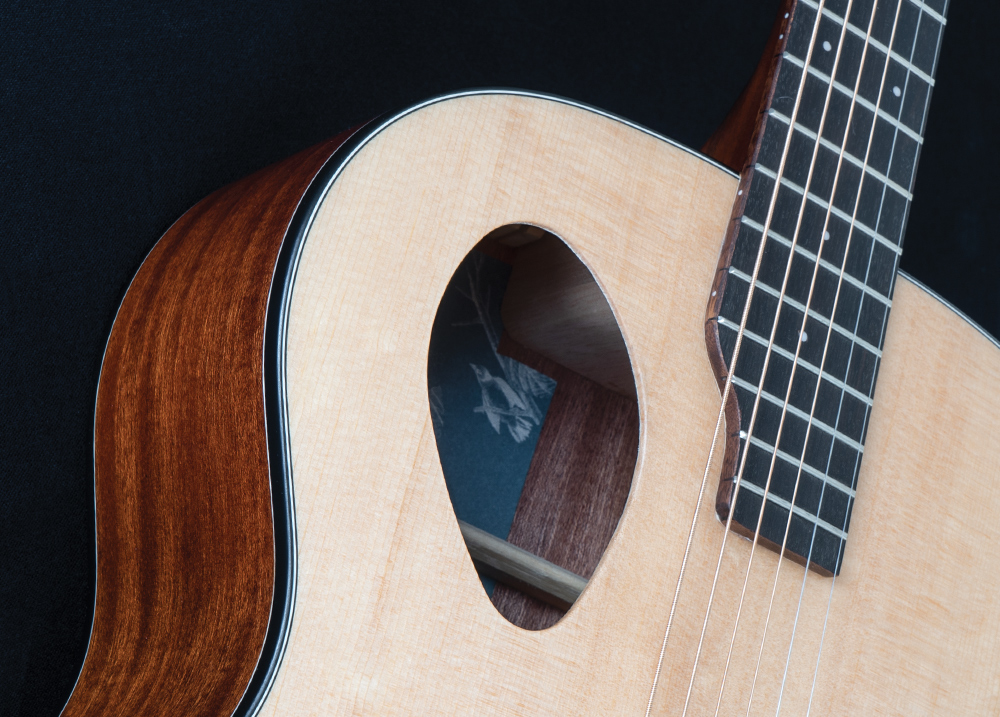 closeup of sound hole on acoustic guitar