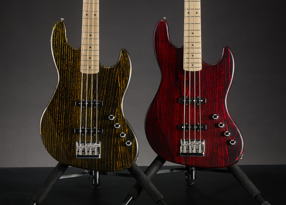 two electric basses on stands