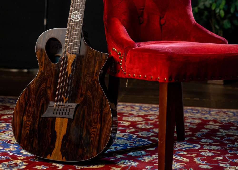 acoustic guitar leaning up against chair