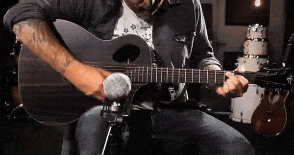 musician playing acoustic guitar gif