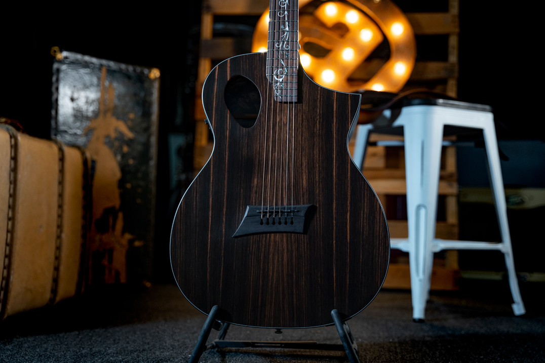 body of acoustic guitar on stand