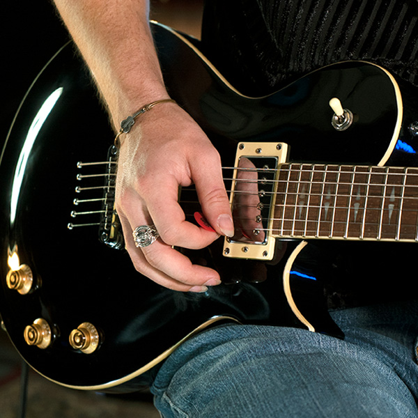 hand playing electric guitar