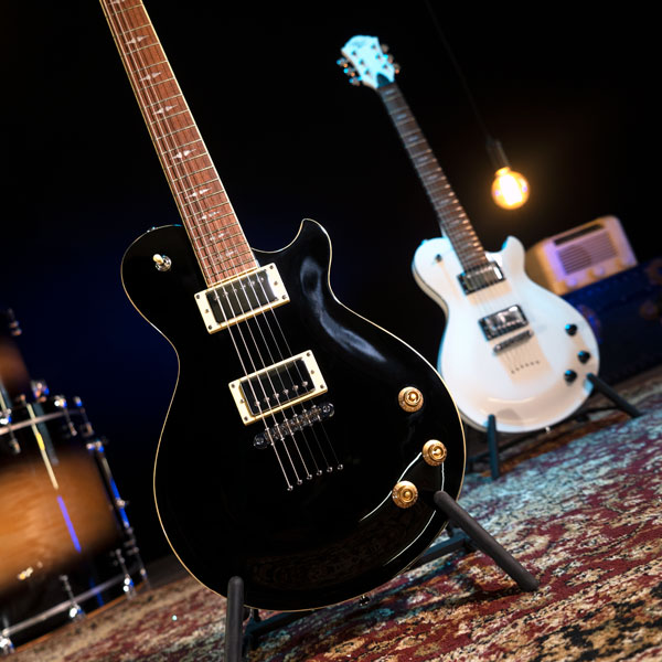 two electric guitars on stands