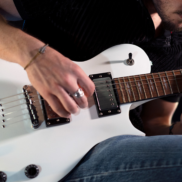 two electric guitars on stands