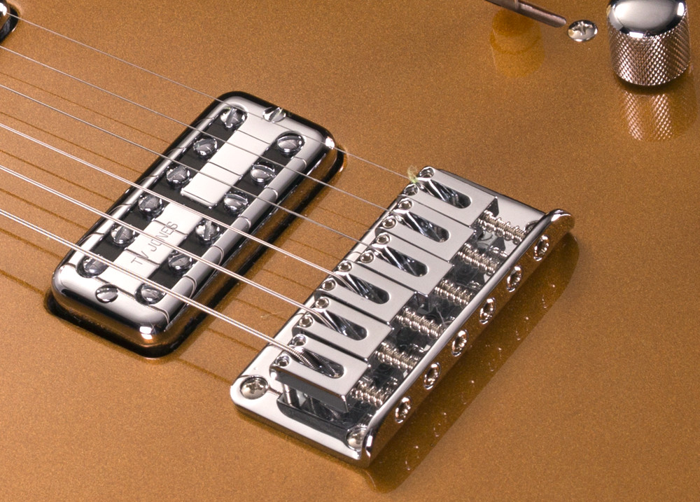 closeup of bridge and pickups on electric guitar